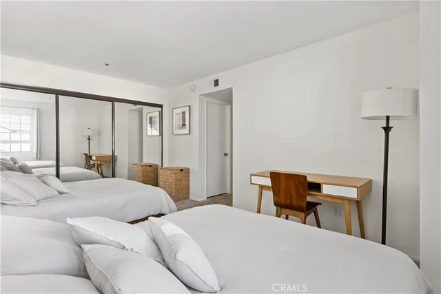 a bedroom with a bed and a table