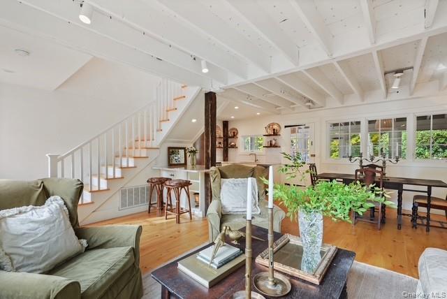 38 A Creemer Road Armonk, NY 10504 - Photo 14 of 23 A view of the open plan first floor and the stair to the second level primary bedroom and primary bath.