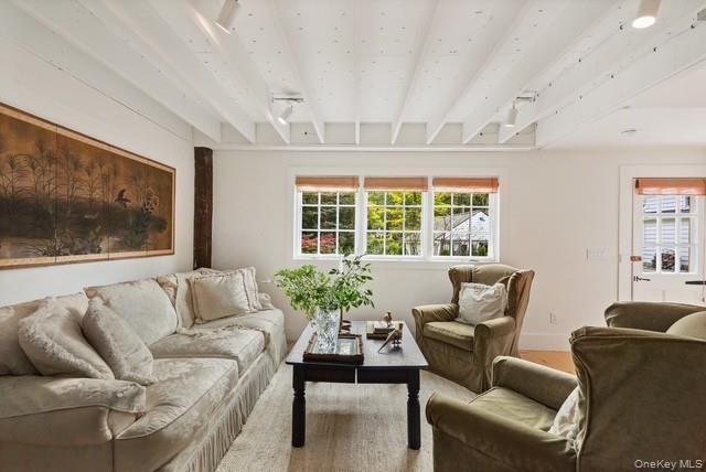 38 A Creemer Road Armonk, NY 10504 - Photo 8 of 23 A view of the bright living room and the back door with some of the rustic charm recreated with the original beams.