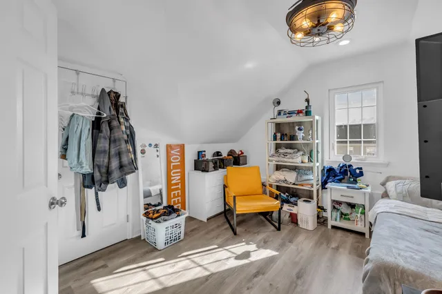 a living room with furniture and a book shelf