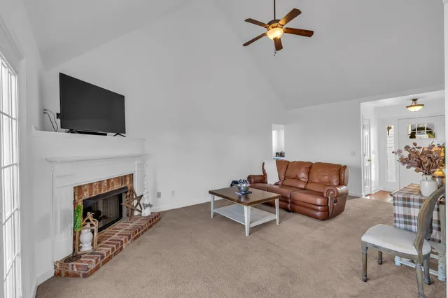 a living room with furniture a fireplace and a flat screen tv