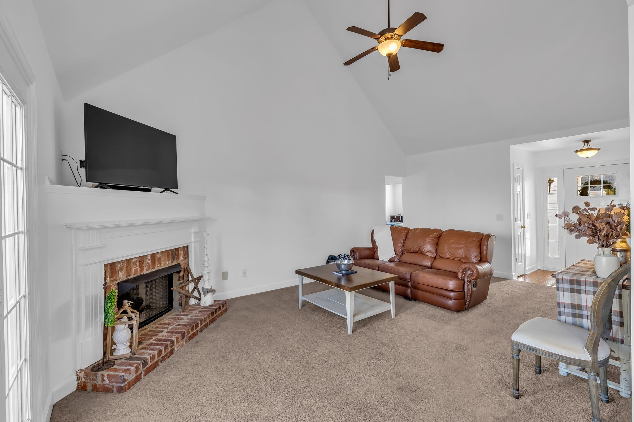 2272 Dewey Drive Spring Hill, TN 37174 - Photo 3 of 14 a living room with furniture a fireplace and a flat screen tv