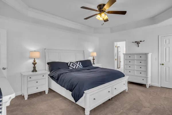 a spacious bedroom with a bed and a closet