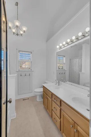 a spacious bathroom with a granite countertop sink a mirror and a vanity