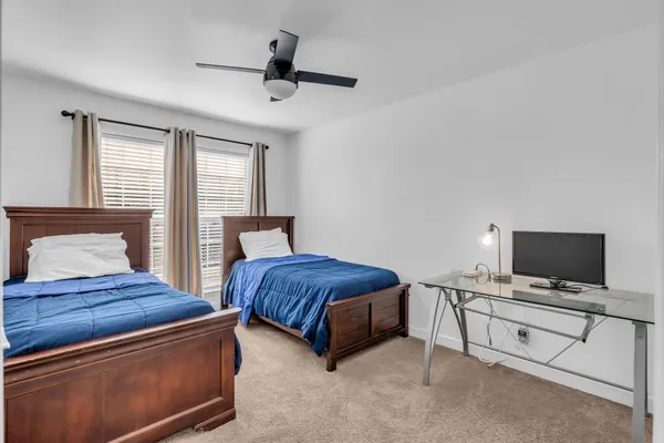 a spacious bedroom with a bed and a tv