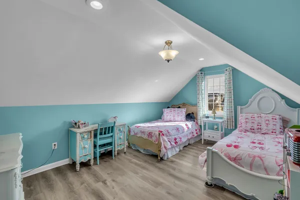 a bedroom with two beds and a large window