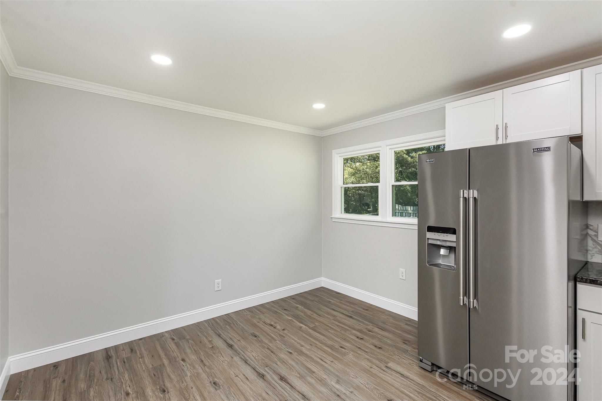 613 Unique Street Chester, SC 29706 - Photo 13 of 27 a view of a kitchen with wooden floor and refrigerator