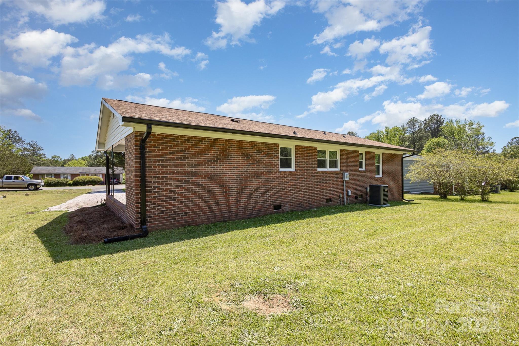 613 Unique Street Chester, SC 29706 - Photo 25 of 27 a backyard of a house with lots of green space and lake view