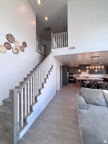 429 East Treasure Road Washington, UT 84780 - Photo 11 of 36 Stairway featuring wood finished floors, recessed lighting, and a high ceiling