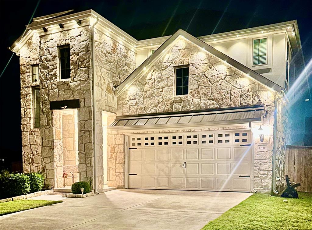 1336 Morning View Road Georgetown, TX 78628 - Photo 40 of 40 Elegant stone masonry and ambient lighting create a captivating evening facade.