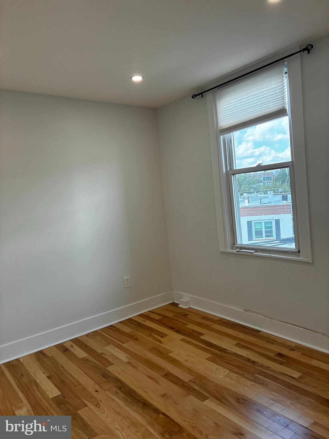 1501 South 12th Street, Unit 3F Philadelphia, PA 19147 - Photo 12 of 23 an empty room with wooden floor and windows