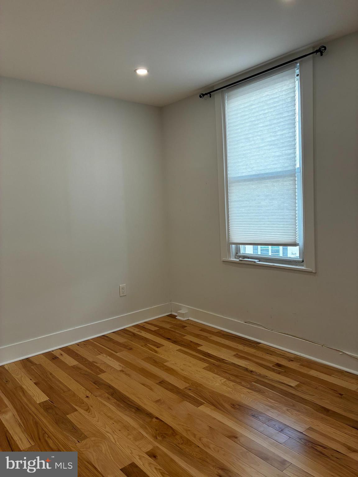 1501 South 12th Street, Unit 3F Philadelphia, PA 19147 - Photo 13 of 23 an empty room with wooden floor and windows