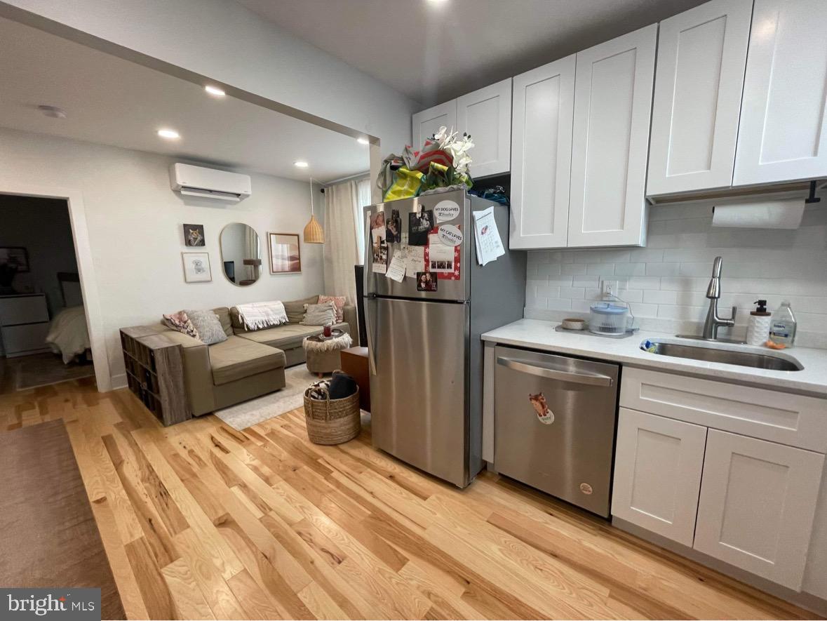 1501 South 12th Street, Unit 3F Philadelphia, PA 19147 - Photo 15 of 23 a kitchen filled with white cabinets and stainless steel appliances