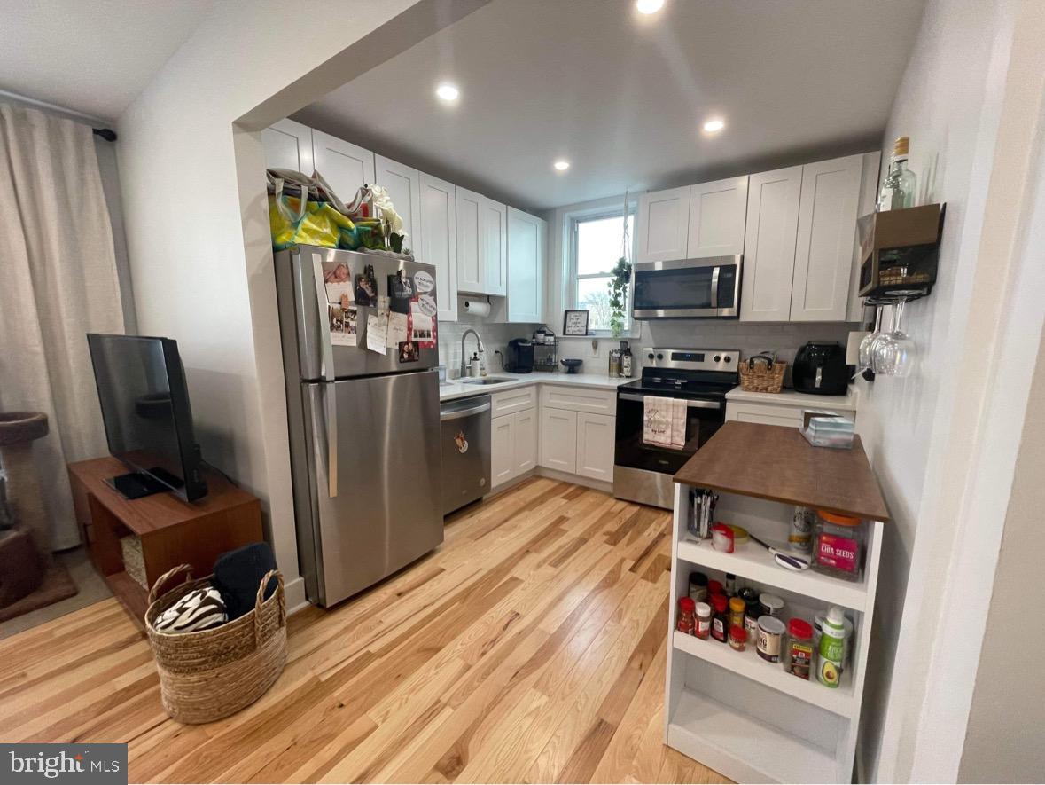 1501 South 12th Street, Unit 3F Philadelphia, PA 19147 - Photo 16 of 23 a kitchen with stainless steel appliances granite countertop a refrigerator stove and microwave