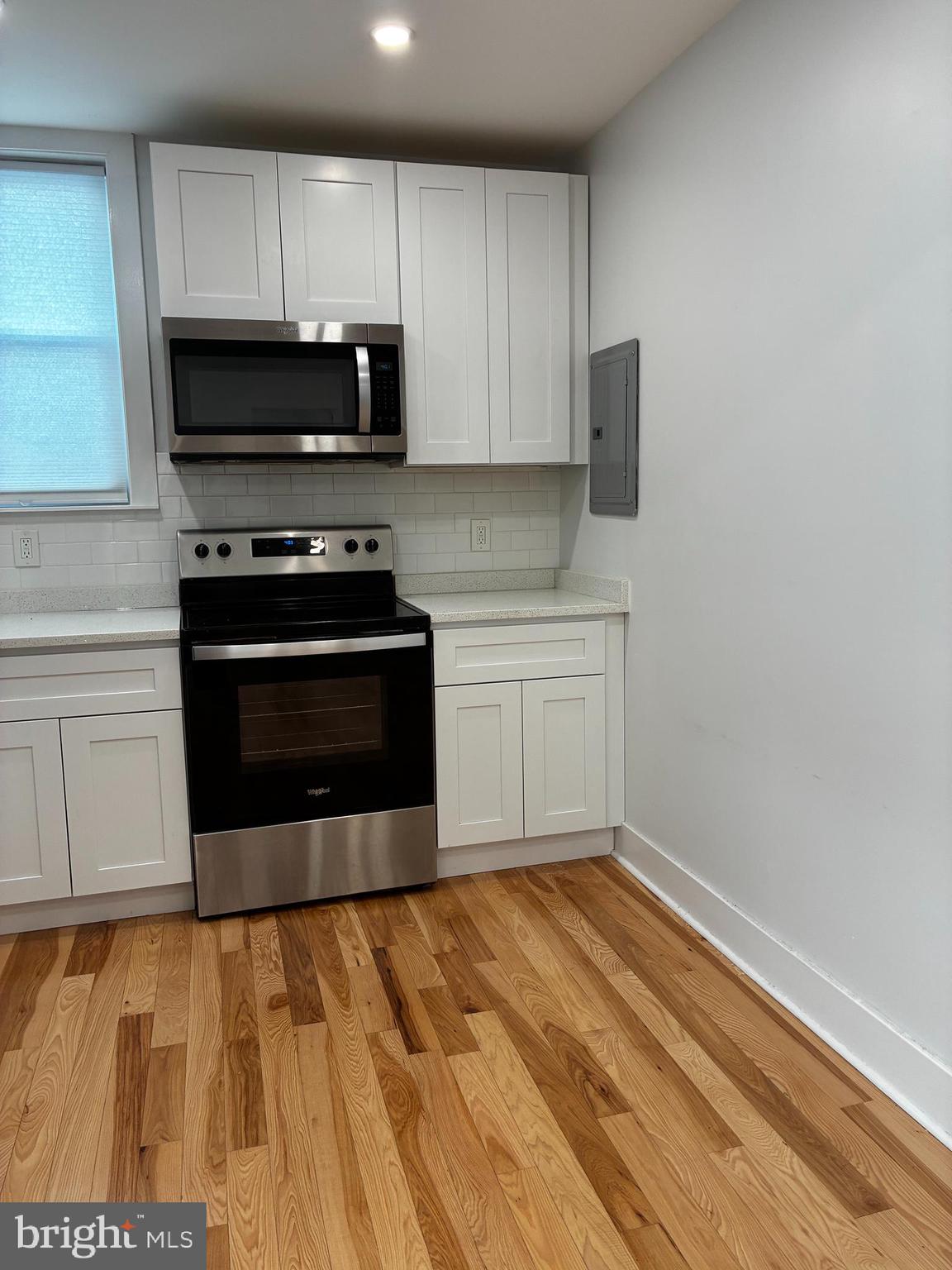 1501 South 12th Street, Unit 3F Philadelphia, PA 19147 - Photo 6 of 23 a kitchen with stainless steel appliances a stove a microwave and sink