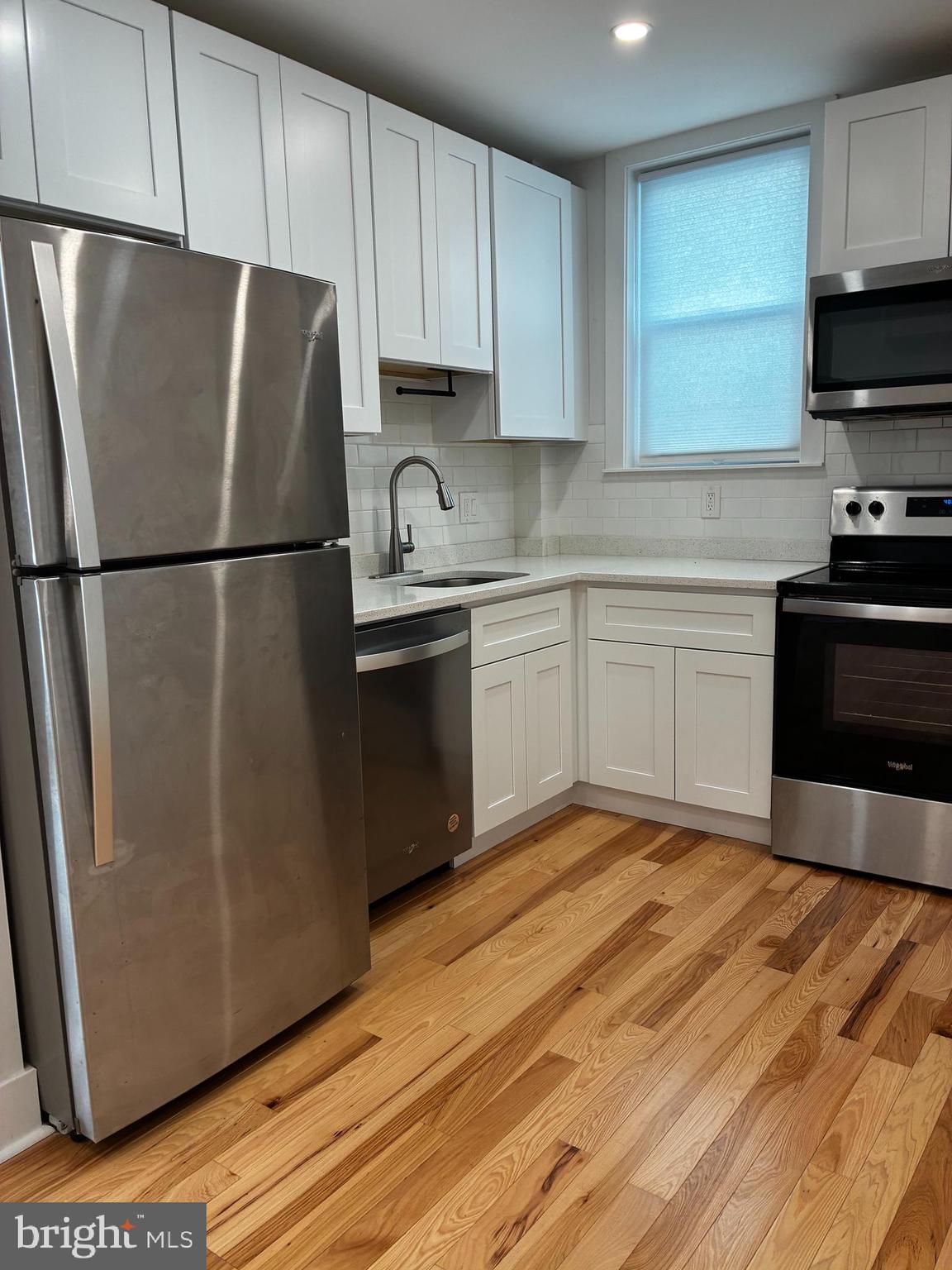 1501 South 12th Street, Unit 3F Philadelphia, PA 19147 - Photo 7 of 23 a kitchen with stainless steel appliances a refrigerator sink and microwave