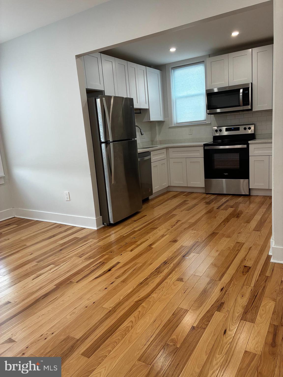 1501 South 12th Street, Unit 3F Philadelphia, PA 19147 - Photo 10 of 23 a kitchen with stainless steel appliances granite countertop a refrigerator stove and microwave