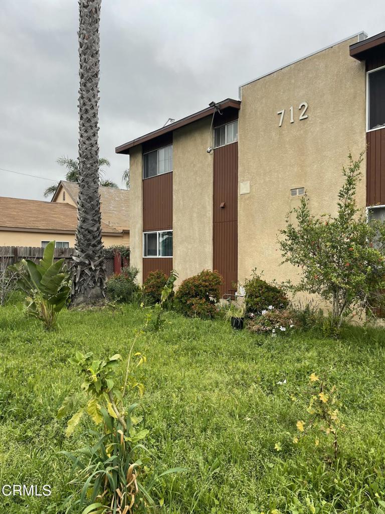 712 South G Street, Unit E Oxnard, CA 93030 - Photo 1 of 12 a front view of a house with garden