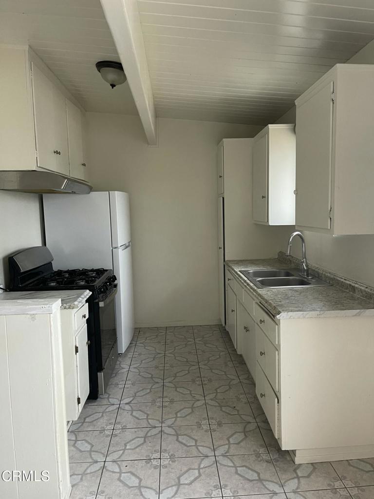 712 South G Street, Unit E Oxnard, CA 93030 - Photo 6 of 12 a kitchen with a sink a stove and refrigerator