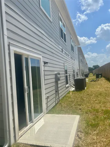 a view of a house with a wooden fence