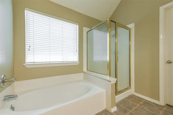 a white bath tub sitting next to a window