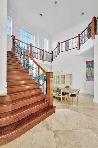 a kitchen with stainless steel appliances kitchen island granite countertop a stove a refrigerator a kitchen island with a dining table and chairs