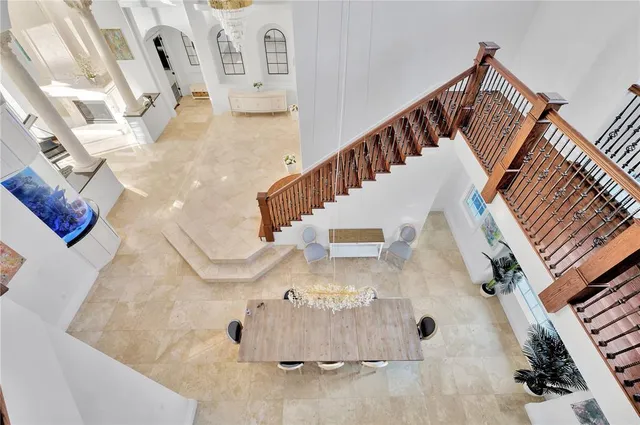 a living room with furniture and a large window with kitchen view