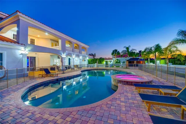 a view of a swimming pool with outdoor seating