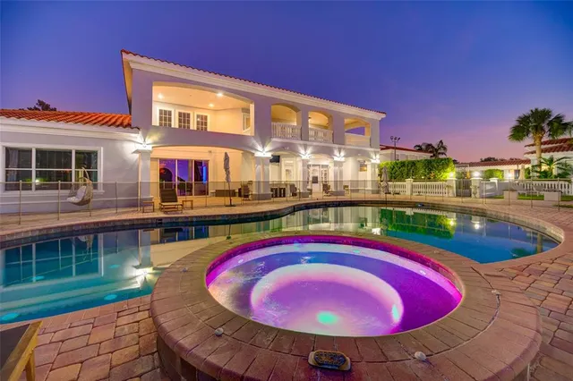 an aerial view of house with yard swimming pool and outdoor seating