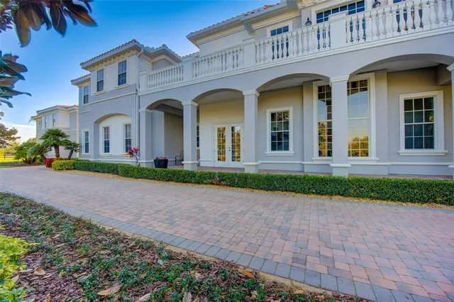 a bedroom with a bed a flat screen tv and a chandelier