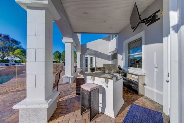a bathroom with a granite countertop shower a sink and a blue shower