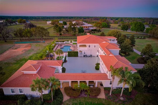 a view of a dining room with furniture a rug and wooden floor