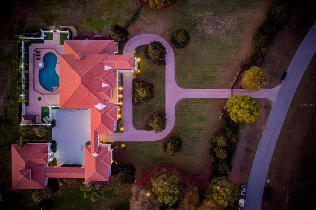 a kitchen with stainless steel appliances kitchen island granite countertop a sink a stove a refrigerator cabinets and chairs