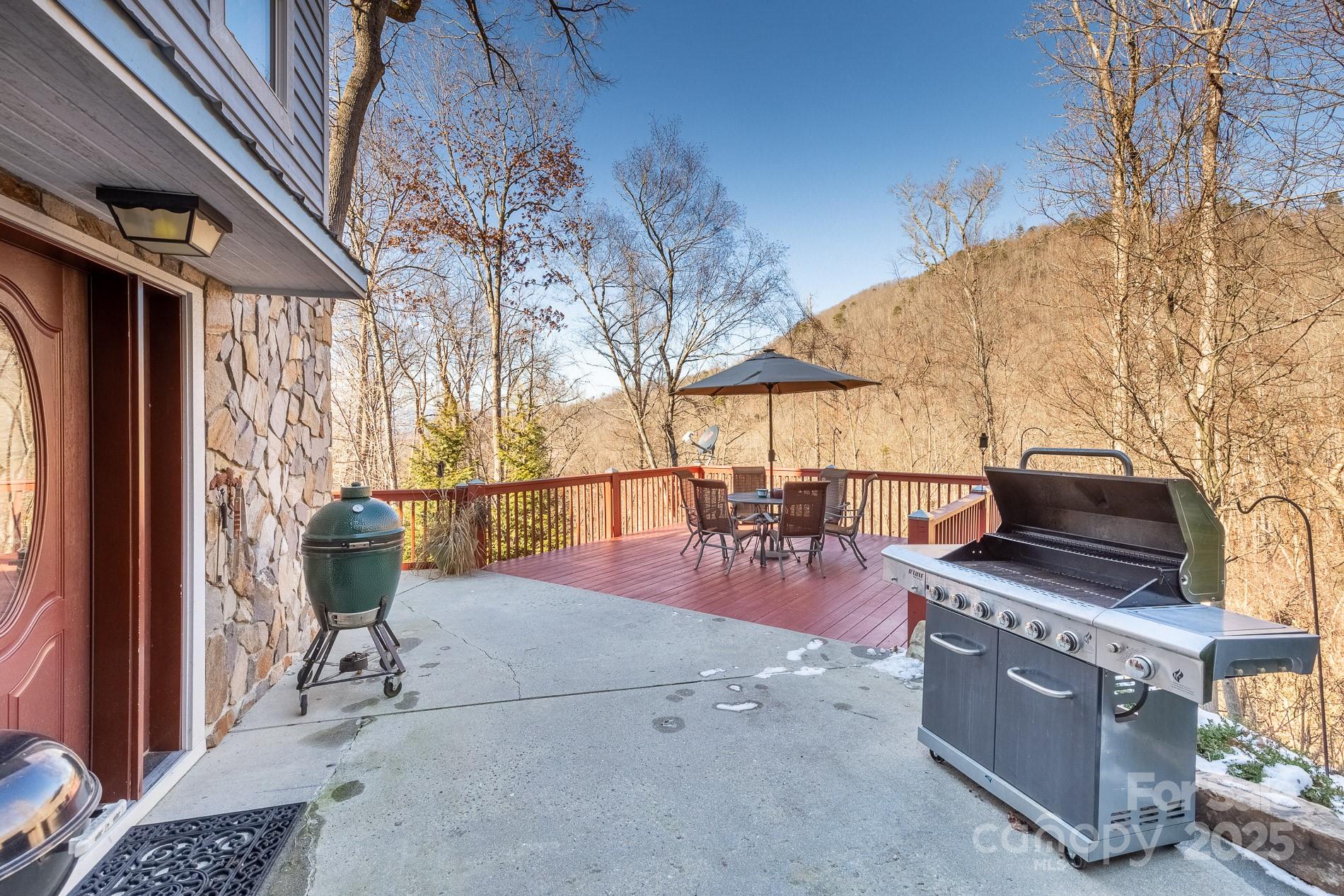 283 Walnut Cv Ridge Bryson City, NC 28713 - Photo 20 of 42 a view of a patio with a dining table and chairs with wooden floor
