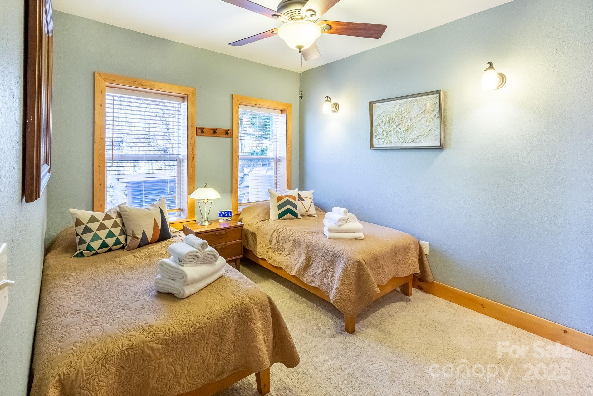 283 Walnut Cv Ridge Bryson City, NC 28713 - Photo 25 of 42 a bedroom with two beds and ceiling fan