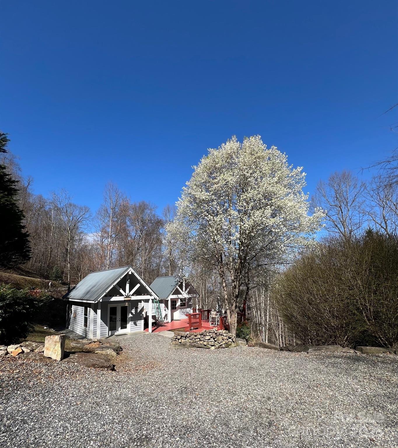 283 Walnut Cv Ridge Bryson City, NC 28713 - Photo 3 of 42 a front view of a house with a yard and garage