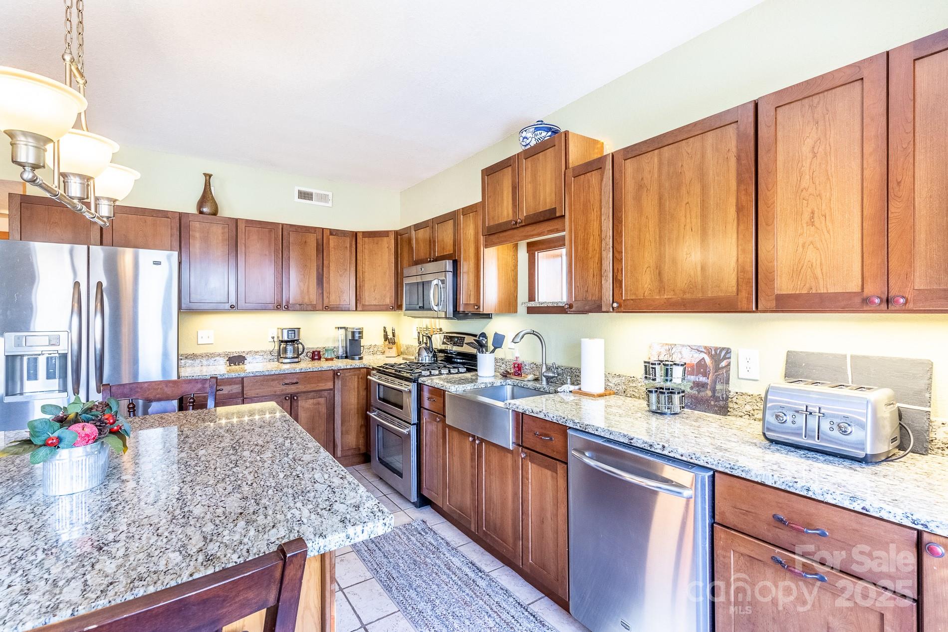 283 Walnut Cv Ridge Bryson City, NC 28713 - Photo 33 of 42 a kitchen with stainless steel appliances granite countertop a sink stove and cabinets