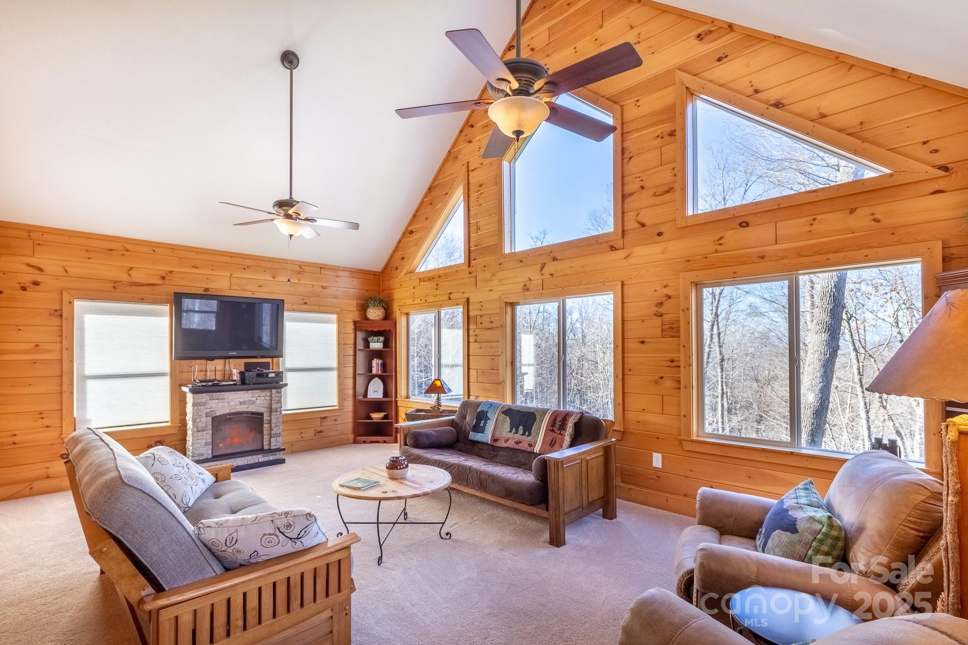 283 Walnut Cv Ridge Bryson City, NC 28713 - Photo 40 of 42 a living room with furniture a fireplace and a flat screen tv