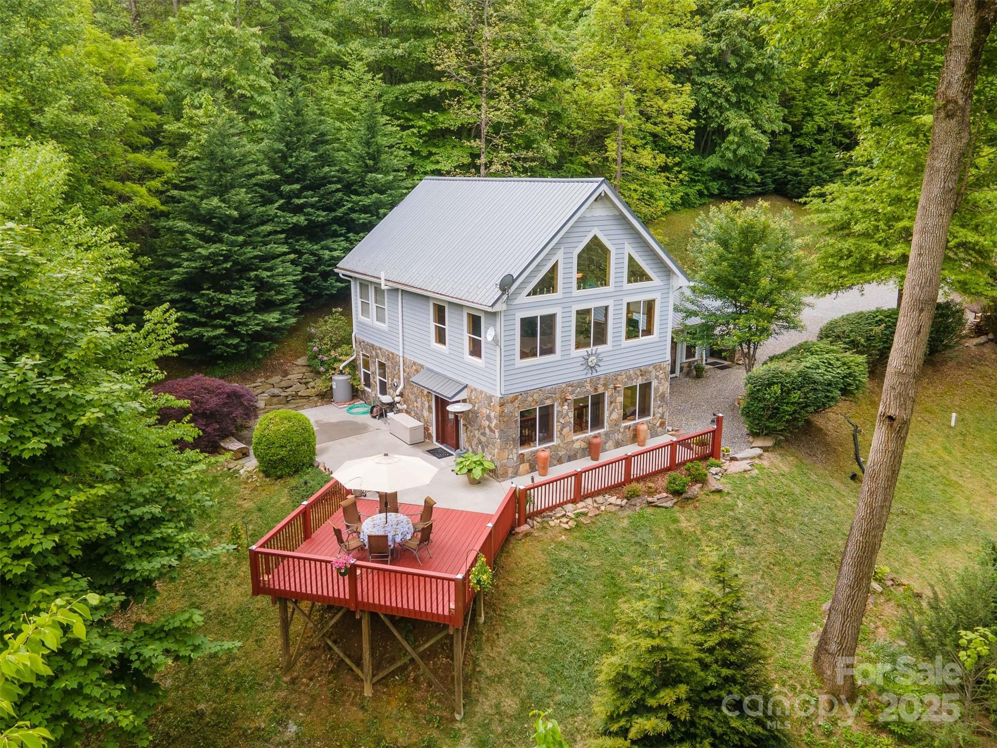 283 Walnut Cv Ridge Bryson City, NC 28713 - Photo 4 of 42 a aerial view of a house with a yard table and chairs