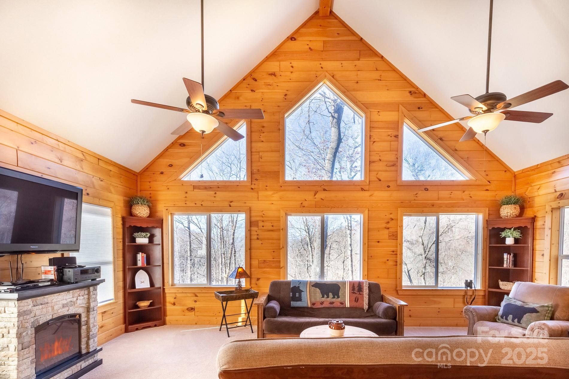 283 Walnut Cv Ridge Bryson City, NC 28713 - Photo 41 of 42 a living room with furniture a flat screen tv and a fireplace