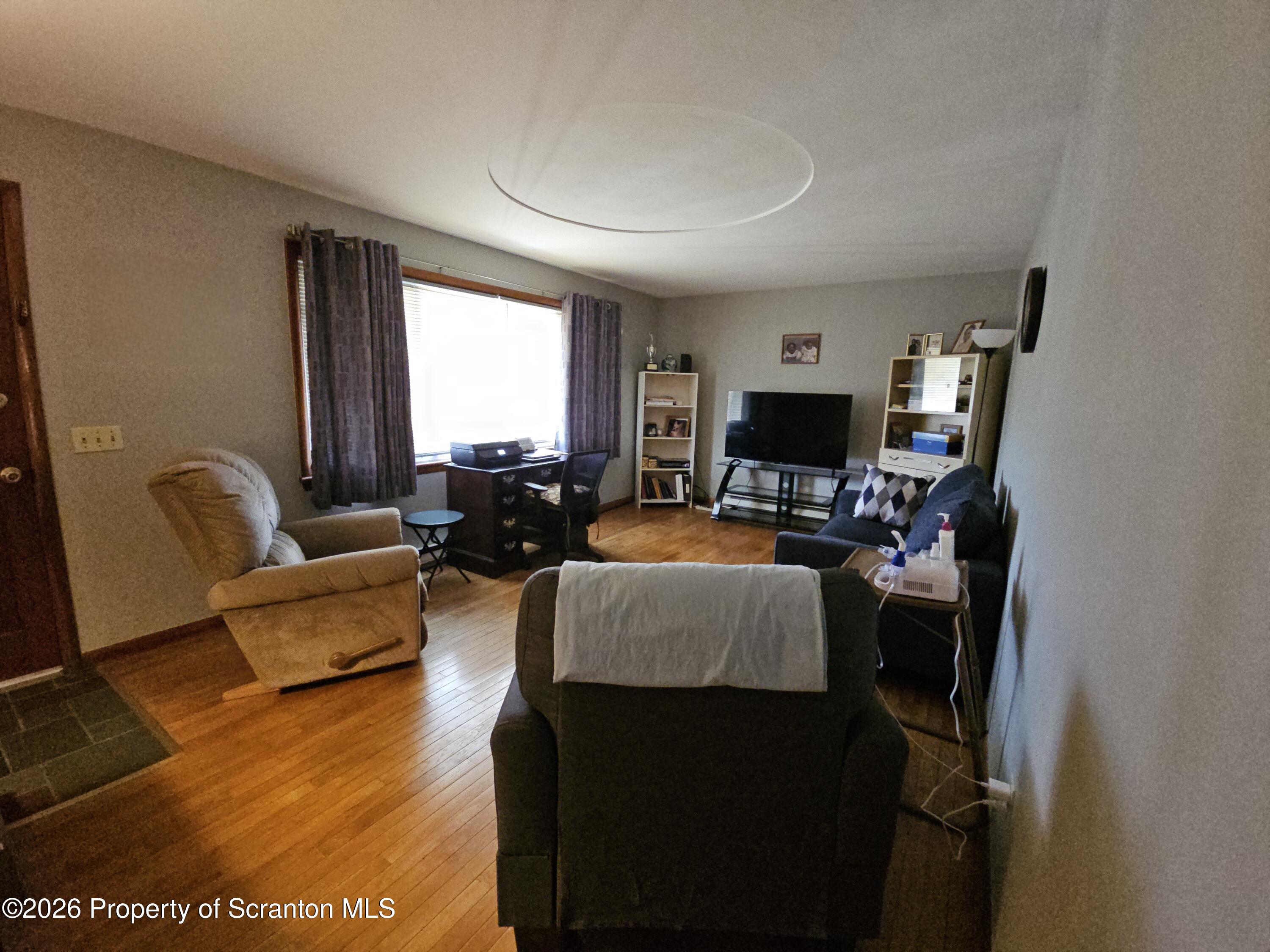 405 Baker Street Taylor, PA 18517 - Photo 14 of 36 a living room with furniture and a flat screen tv