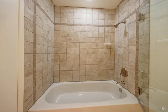 a bath tub sitting next to a shower