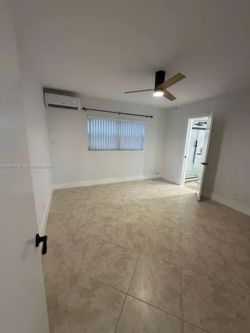 a view of an empty room with a ceiling fan