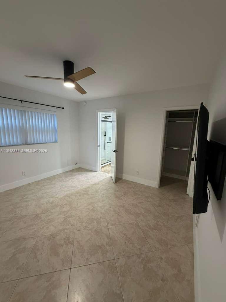 3208 Colony Club Road, Unit 2 Pompano Beach, FL 33062 - Photo 13 of 18 a view of an empty room with a ceiling fan