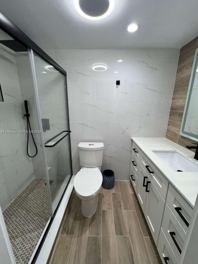 3208 Colony Club Road, Unit 2 Pompano Beach, FL 33062 - Photo 15 of 18 a bathroom with a granite countertop sink toilet and shower