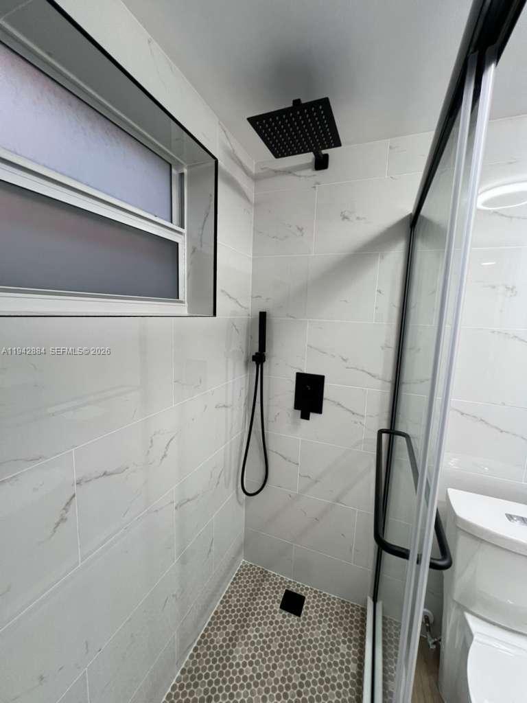 3208 Colony Club Road, Unit 2 Pompano Beach, FL 33062 - Photo 16 of 18 a bathroom with a shower