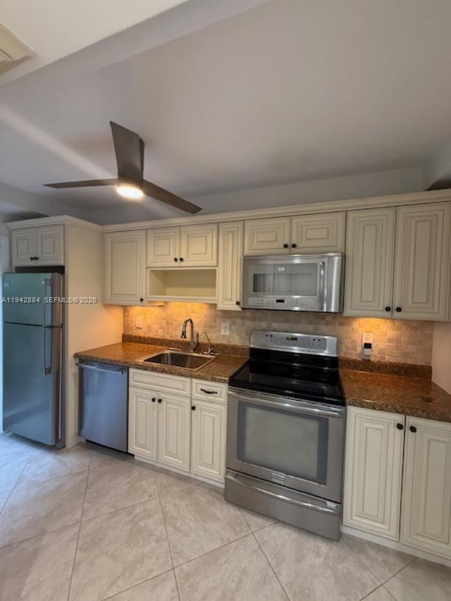 3208 Colony Club Road, Unit 2 Pompano Beach, FL 33062 - Photo 2 of 18 a kitchen with stainless steel appliances granite countertop a stove and a sink