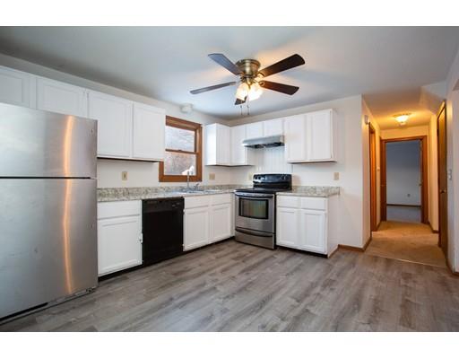 152 Starling Road Springfield, MA 01119 - Photo 5 of 28 a kitchen with a refrigerator and white cabinets