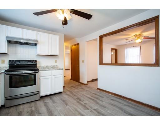 152 Starling Road Springfield, MA 01119 - Photo 6 of 28 a kitchen with stainless steel appliances a stove a sink and a microwave