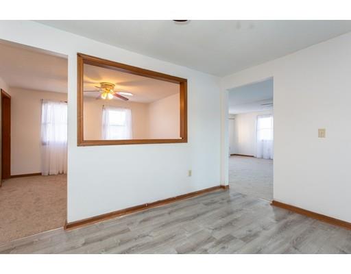 152 Starling Road Springfield, MA 01119 - Photo 8 of 28 a view of an empty room with wooden floor and a window